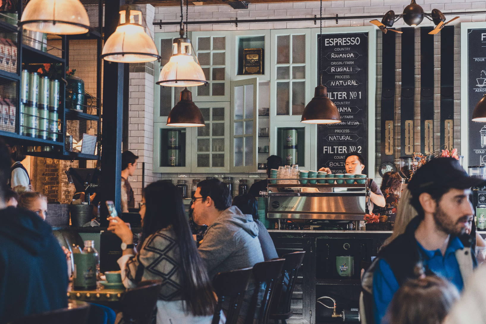 A busy neighbourhood coffee shop with people talking over coffee